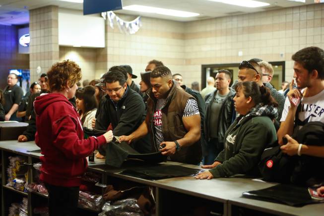 UFC fans purchase shirts after the weigh in for UFC 155, Friday, Dec. 28, 2012.