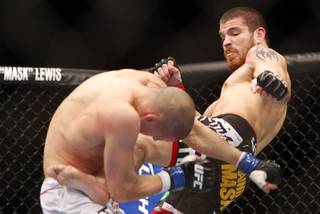Jim Miller of Whippany, N.J. kicks Joe Lauzon of Bridgewater, Mass. during the first round of a lightweight bout UFC155 at the MGM Grand Garden Arena Saturday, Dec. 29, 2012. Miller defeated Lauzon by unanimous decision.