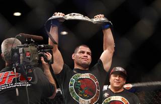 Cain Velasquez holds up the championship belt after defeating Junior Dos Santos during a heavyweight title bout UFC155 at the MGM Grand Garden Arena Saturday, Dec. 29, 2012. Velasquez reclaimed the belt by unanimous decision.