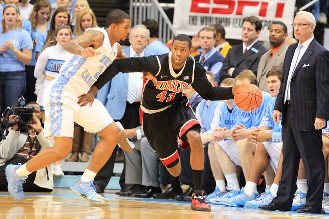 UNLV forward Mike Moser is guarded by North Carolina forward Leslie McDonald during their game Saturday, Dec. 29, 2012 at the Dean Smith Center in Chapel Hill, N.C.
