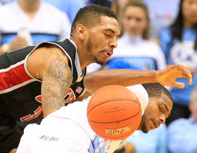 UNLV guard Anthony Marshall knocks the ball away from North Carolina guard Joel James during their game Saturday, Dec. 29, 2012 at the Dean Smith Center in Chapel Hill, N.C. North Carolina won the game 79-73.