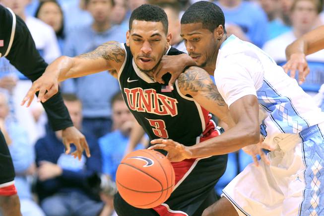 UNLV guard Anthony Marshall defends North Carolina guard Dexter Strickland during their game Saturday, Dec. 29, 2012 at the Dean Smith Center in Chapel Hill, N.C. North Carolina won the game 79-73.