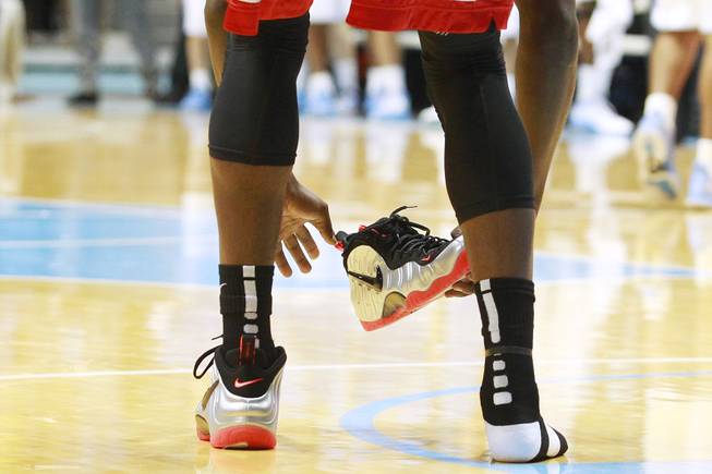 UNLV forward Savon Goodman puts his shoe back on during their game against North Carolina Saturday, Dec. 29, 2012 at the Dean Smith Center in Chapel Hill, N.C. North Carolina won the game 79-73.