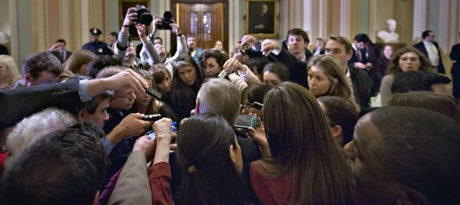Reporters surround Assistant Majority Leader Sen. Richard Durbin, D-Ill., outside the Senate chamber during negotiations on the "fiscal cliff" at the Capitol in Washington, Sunday, Dec. 30, 2012.