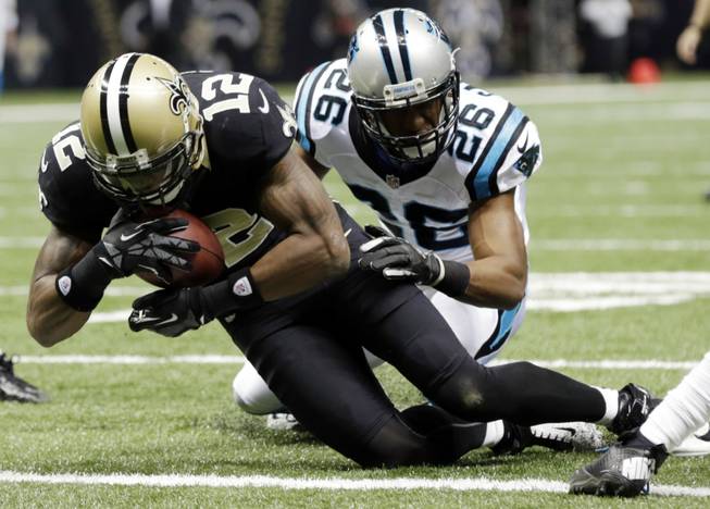 New Orleans Saints' Marques Colston (12) catches a seven-yard touchdown pass with Carolina Panthers' D.J. Campbell (26) defending during the first half of an NFL football game Sunday, Dec. 30, 2012, in New Orleans. 