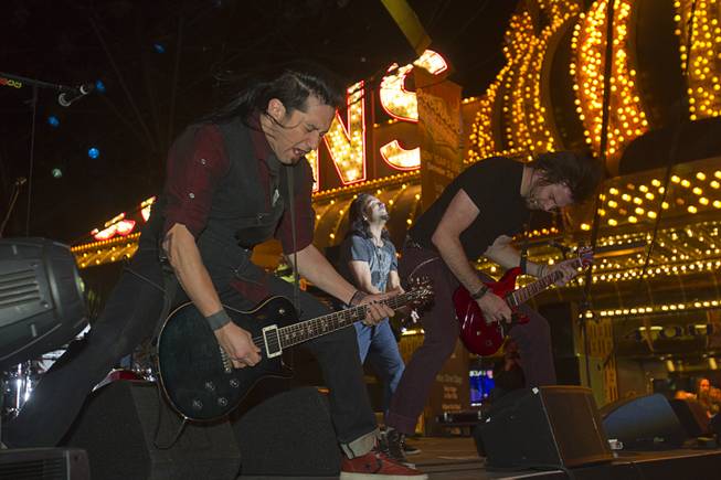 Members of the band Pop Evil perform during the New Years Eve party at the Fremont Street Experience Monday, Dec. 31, 2012.