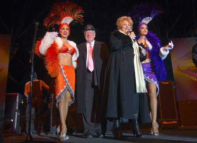 Las Vegas Mayor Carolyn Goodman and her husband Oscar Goodman arrive with showgirls Jennifer Johnson, left, and Porsha Revesz during the New Years Eve party at the Fremont Street Experience Monday, Dec. 31, 2012.