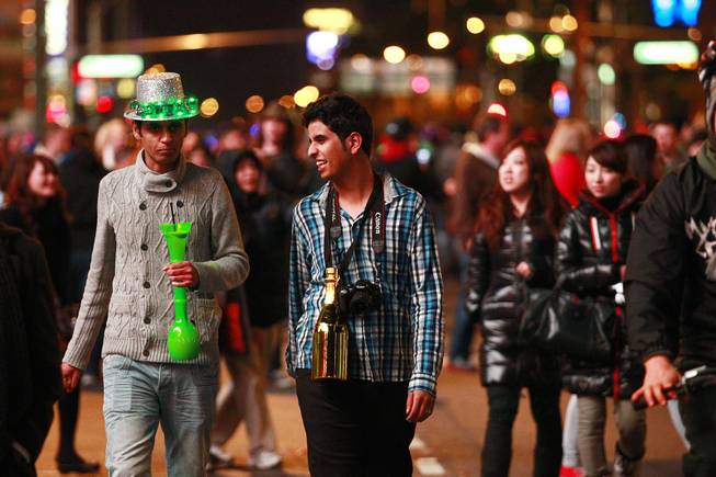 Revelers walk up and down the Strip for the annual New Year's Eve celebration Monday, Dec. 31, 2012.