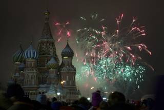 Fireworks explode in the sky over St. Basil Cathedral as Russians celebrate New Year on Red Square in Moscow, Russia, on Tuesday, Jan. 1, 2013. 