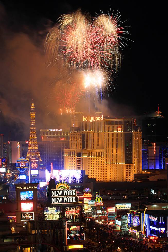 Fireworks explode from the tops of casinos on the Strip during the annual New Year's Eve celebration in Las Vegas Tuesday, Jan.1, 2013.