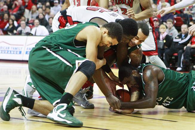 UNLV forward Anthony Bennett fights for a loose ball with Chicago State's Clarke Rosenberg, left, Jeremy Robinson and Quinton Pippen, right, during their game Thursday, Jan. 3, 2013 at the Thomas & Mack Center. UNLV won the game 74-52.