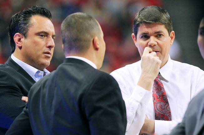 UNLV coaches Heath Schroyer, Justin Hutson and Dave Rice confer during a timeout in their game against Chicago State Thursday, Jan. 3, 2013 at the Thomas & Mack Center. UNLV won the game 74-52.