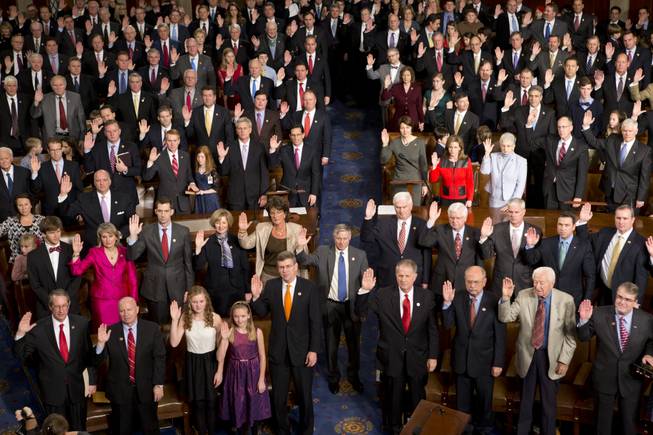 Members of the 113th Congress, many accompanied by family members, take the oath of office in the House of Representatives chamber on Capitol Hill in Washington, Thursday, Jan. 3, 2013.