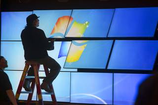 A technician works on a video wall for a Samsung booth in the Las Vegas Convention Center lobby as exhibitors prepare for the International Consumer Electronics Show in Las Vegas on Friday, Jan. 5, 2013. The show begins Jan. 8.