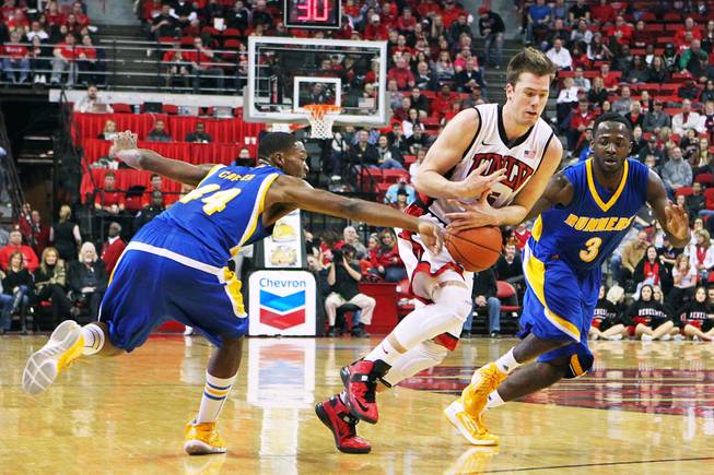 UNLV guard Katin Reinhardt loses the ball while being defended by Cal State Bakersfield guards Stephon Carter, left, and Javonte Maynor during their game Saturday, Jan. 5, 2013, at the Thomas & Mack Center. UNLV won their non-conference finale 84-63.