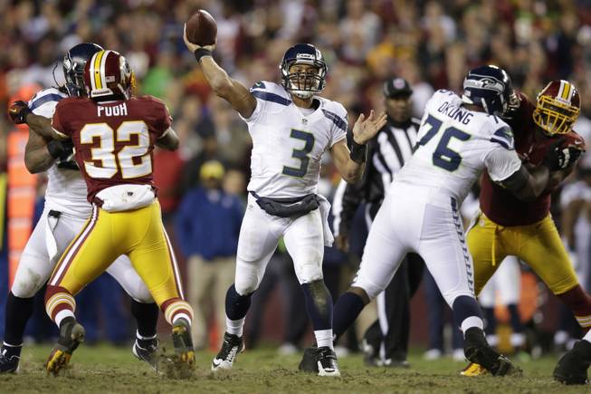 Seattle Seahawks quarterback Russell Wilson throws a pass during the second half of an NFL wild card playoff football game against the Washington Redskins in Landover, Md., Sunday, Jan. 6, 2013.