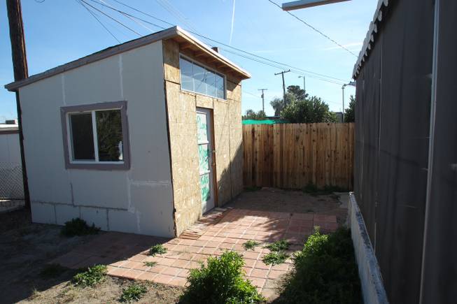 An unfinished shed is seen in the back yard of Tobie Ortiz's Henderson house Tuesday, Jan. 8, 2013 which she bought out of foreclosure.