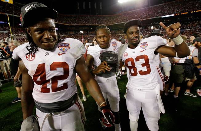 Alabama 's Eddie Lacy (42), Kenny Bell (7) and Kevin Norwood (83) celebrate after the BCS National Championship college football game against Notre Dame Monday, Jan. 7, 2013, in Miami. Alabama won 42-14.