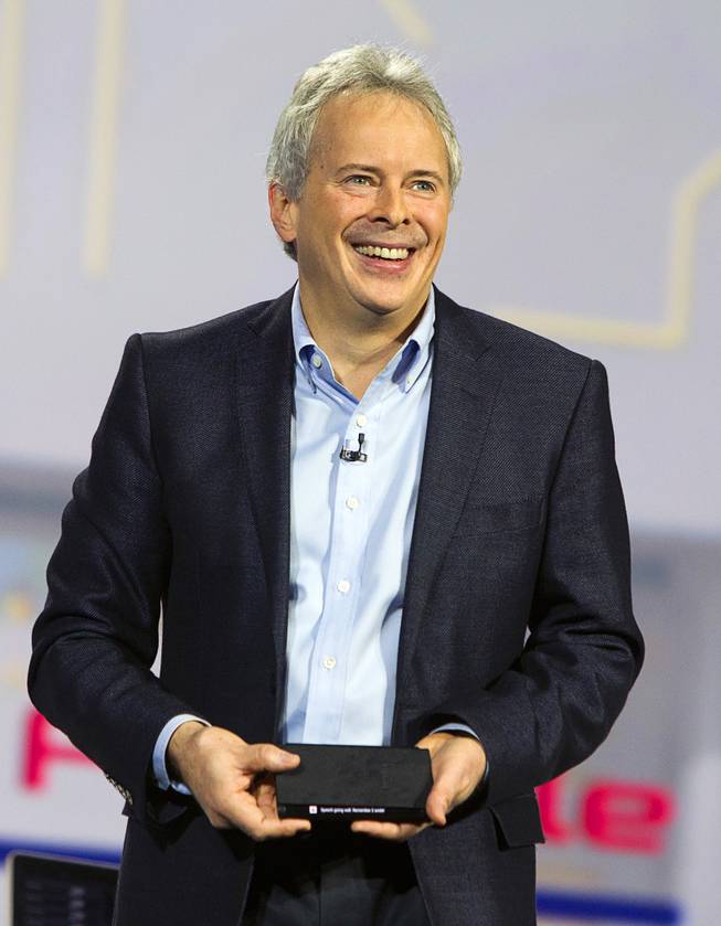 Brian Berkeley, senior vice president for Samsung's San Jose Display Lab, holds a prototype device with a wrap-around, flexible OLED screen during a keynote address at the 2013 International CES Wednesday January 9, 2013.