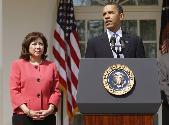 This April 15, 2010, file photo shows Labor Secretary Hilda Solis standing with President Barack Obama in the Rose Garden of the White House in Washington. Solis is telling colleagues she is leaving the Obama administration.