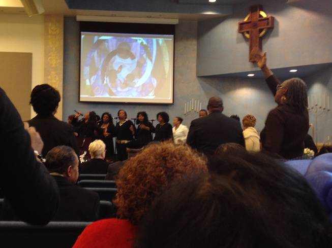 Mourners clap and sing to a gospel song at Jade Morris' funeral. Hundreds of people filled Bread of Life Ministry to celebrate the 10-year-old's life on Tuesday. 
