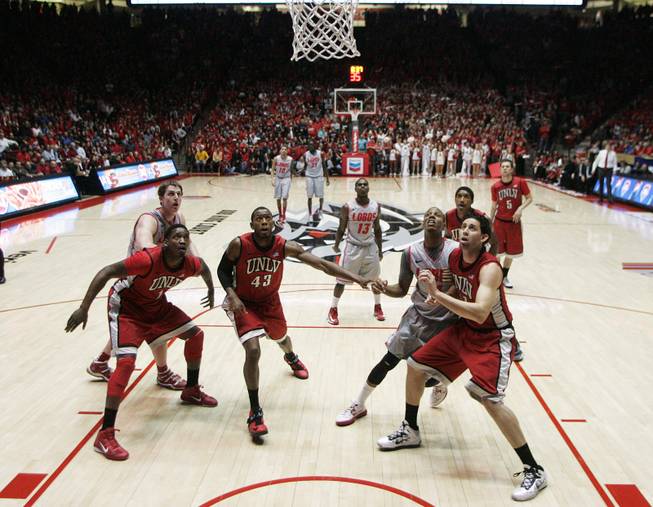 From left, UNLV forwards Quintrell Thomas, Mike Moser and Carlos Lopez-Sosa box out on New Mexico guard Jamal Fenton's free throw attempt during the second half of their game Wednesday, Jan. 9, 2013 at The Pit in Albuquerque. 