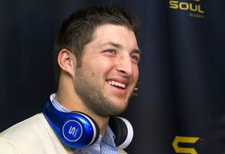 New York Jets quarterback Tim Tebow arrives at a news conference to promote Tim Tebow Signature Series headphones by Soul Electronics during the 2013 International CES on Thursday, Jan. 10, 2013.