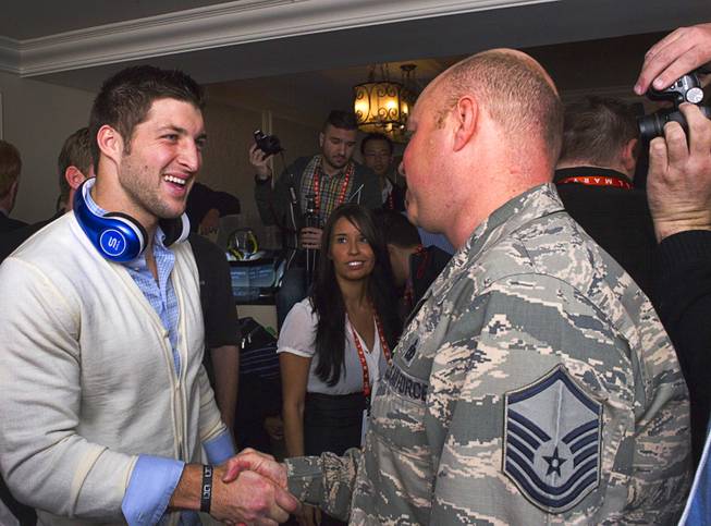 NFL quarterback Tim Tebow meets with reporters and guests following a news conference to promote the Tim Tebow Signature Series headphones by Soul Electronics at the 2013 International CES Thursday, Jan. 10, 2013.