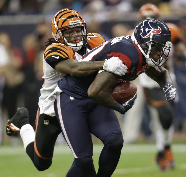 Houston Texans wide receiver Andre Johnson (80) is tackled by Cincinnati Bengals cornerback Adam Jones (24) during the third quarter of an NFL wild card playoff football game Saturday, Jan. 5, 2013, in Houston.