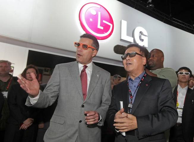 Nevada Governor Brian Sandoval, left, and Wayne Park, President and CEO LG Electronics North America, right, wear 3D glasses as they watch a demonstration of LG's revolutionary curved OLED TV shown for the first time at the 2013 International CES in Las Vegas , NV, Thursday, January 10, 2013.  