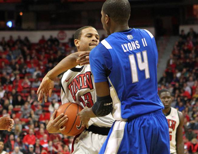 UNLV guard Bryce Dejean-Jones keeps Air Force guard Michael Lyons away from his rebound during their game Saturday, Jan. 12, 2013 at the Thomas & Mack. UNLV won in overtime, 76-71.