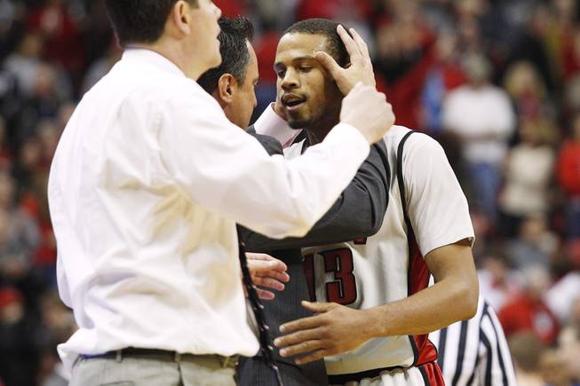 UNLV assistant coach Heath Schroyer grabs guard Bryce Dejean-Jones by the head after he sunk the go ahead basket in overtime against Air Force Saturday, Jan. 12, 2013 at the Thomas & Mack. UNLV won in overtime, 76-71.