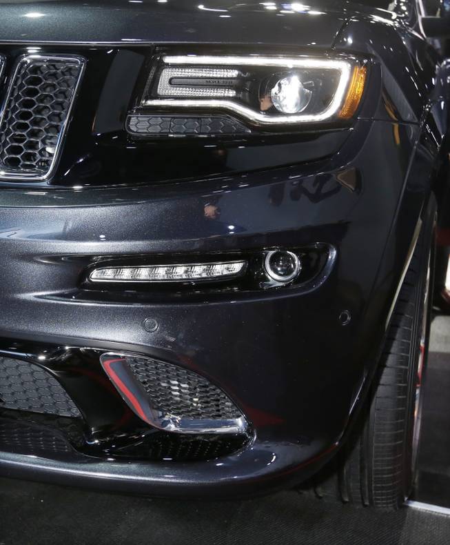 The front lamps on the high-performance SRT version of the 2014 Jeep Grand Cherokee are seen at the North American International Auto Show in Detroit, Tuesday, Jan. 15, 2013. The lamps are tinted black, giving it a distinct look. Ralph Gilles, a Chrysler design leader who also is president and CEO of the SRT brand and motorsports, noted the vehicle has black "kind of like death", headlamps.