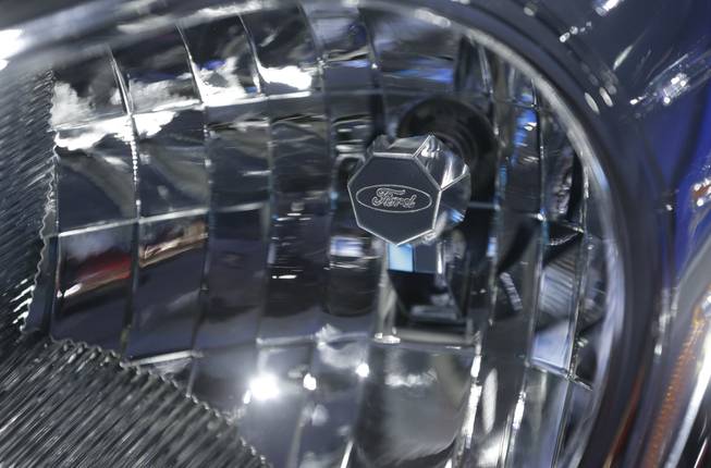 A headlight with a Ford logo is shown on the Ford Transit van at the North American International Auto Show in Detroit, Tuesday, Jan. 15, 2013.