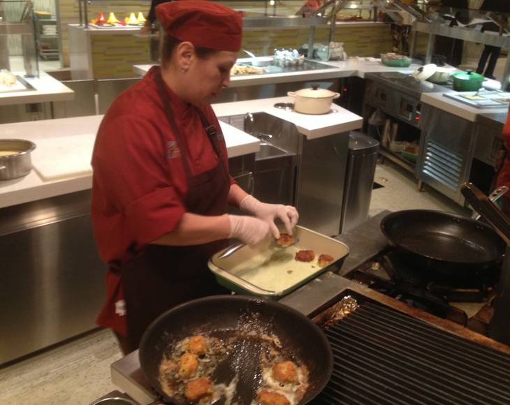 A cook prepares food to order on the Aria Buffet after renovations on Jan. 11, 2013.