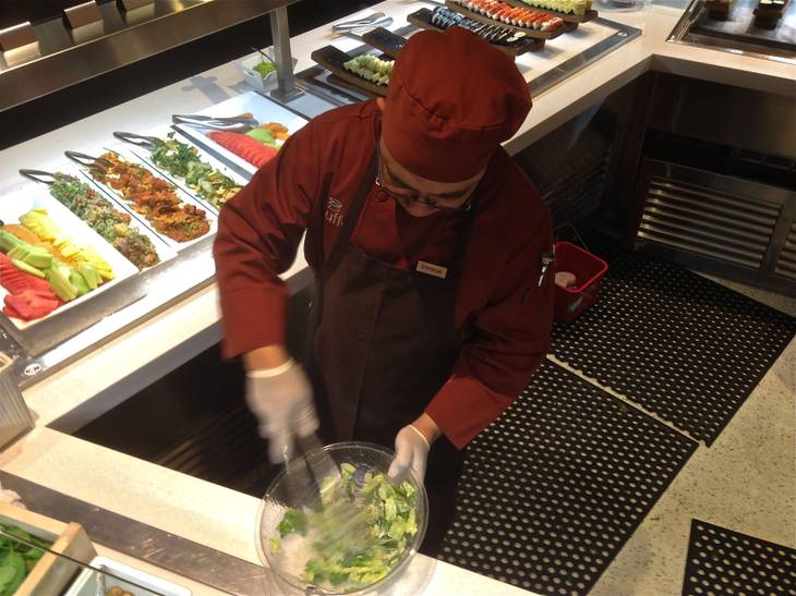 A staff member mixes a salad for a customer at the Aria Buffet after renovations on Jan. 11, 2013.