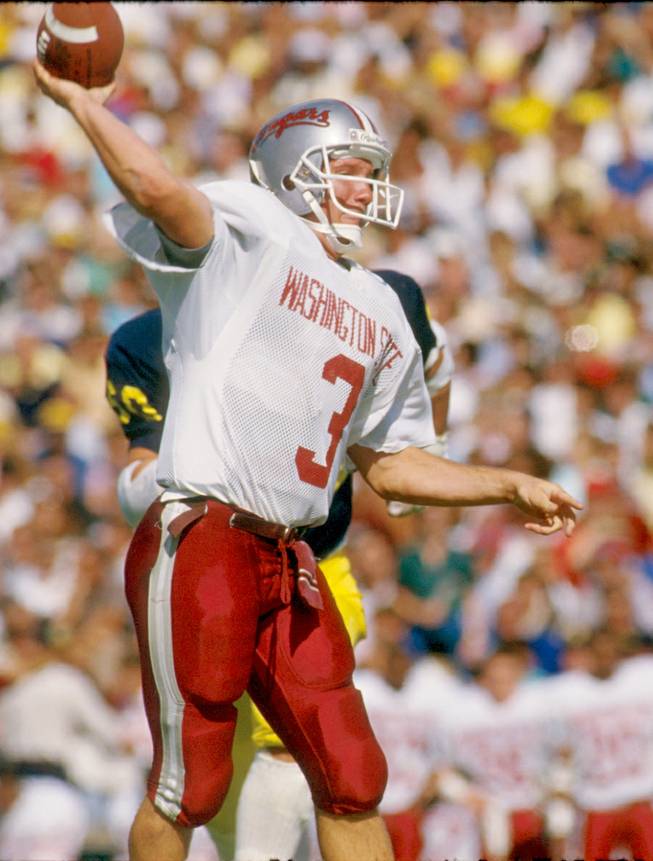 Former Washington State quarterback Timm Rosenbach attempts a pass for the Cougars. Rosenbach, who is the new UNLV offensive coordinator, finished seventh in the Heisman Trophy voting in 1988 and would go on to play several seasons in the NFL and CFL.