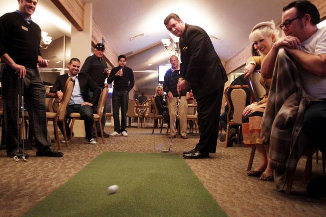 Dan Stafford participates in the putting contest during a Paradise Palms cocktail party at Las Vegas National Golf Club on Friday, January 18, 2013.