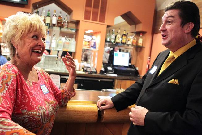 Sandra Duffy, left, chats with Dan Stafford during a Paradise Palms cocktail party at Las Vegas National Golf Club on Friday, January 18, 2013.