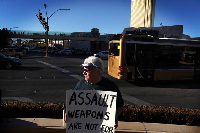 Jim Walsh of Las Vegas, the organizer, holds a sign during a demonstration in favor of President Obama's new gun regulations outside of the Palazzo on the Strip in Las Vegas on Saturday, January 19, 2013.