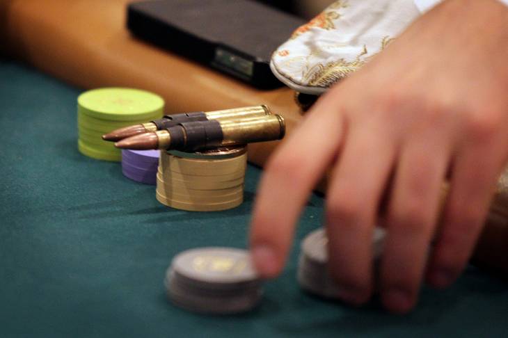 A player uses bullets as his good luck charm during the MBA Poker Championship and Recruitment Weekend at Planet Hollywood in Las Vegas on Saturday, January 19, 2013.