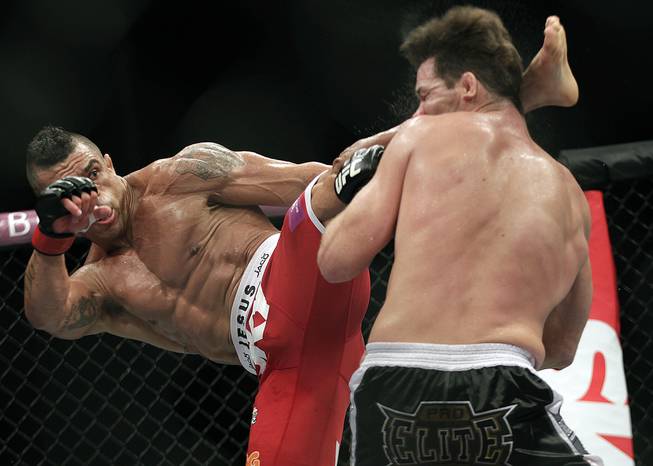 Vitor Belfort, from Brazil, left, kicks Michael Bisping, from Britain during their middleweight mixed martial arts bout at the Ultimate Fighting Championship (UFC) in Sao Paulo, Brazil, Sunday, Jan. 20, 2013. 