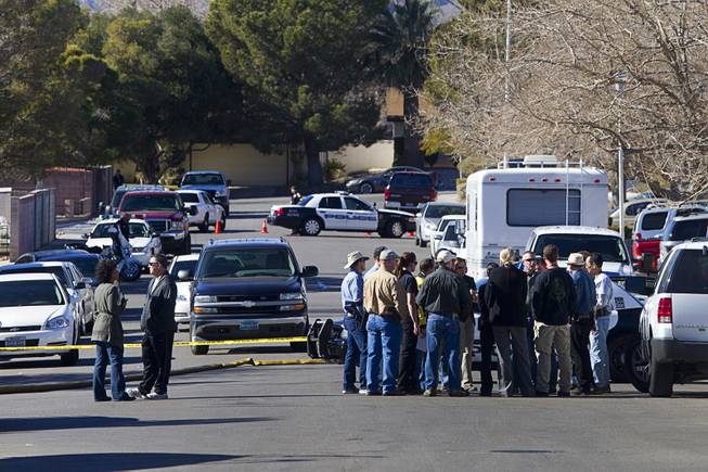 Law enforcement officials confer during a shooting investigation in Boulder City, Jan. 21, 2013.