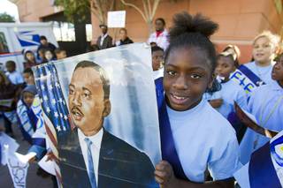 Shania Washington, a fourth grader at Kelly Elementary School, holds a portrait of Martin Luther King Jr. during the 31st annual MLK JR. parade in downtown Las Vegas, Monday, Jan. 21, 2013. MGM Resorts International was the presenting sponsor for the event.