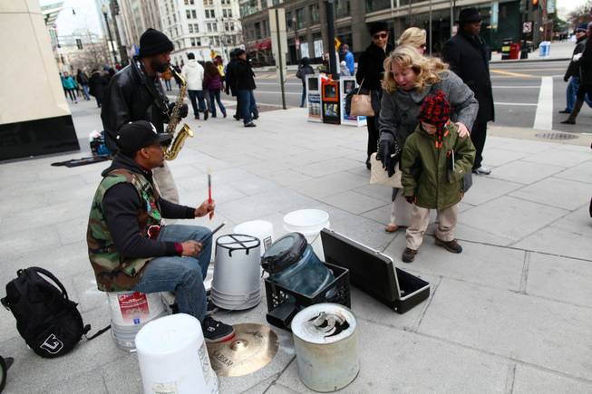 Saxophonist Tim Turner and drummer Markiee Wright play for passers-by at the corner of 13th Street and New York Avenue in Northwest Washington D.C. Monday morning, Jan. 21, 2013.