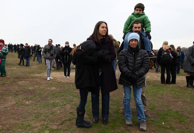 Corina Gonzalez and her husband Mark Pineda with their three kids, Olivia in the foreground, Nicolas on Pineda's shoulders, and Sophia, huddled against her mother, on the National Mall to watch the presidential inauguration ceremonies Monday, Jan. 21, 2013.