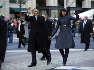 President Barack Obama and first lady Michelle Obama walk down Pennsylvania Avenue during the 57th Presidential Inauguration parade Monday, Jan. 21, 2013, in Washington. 