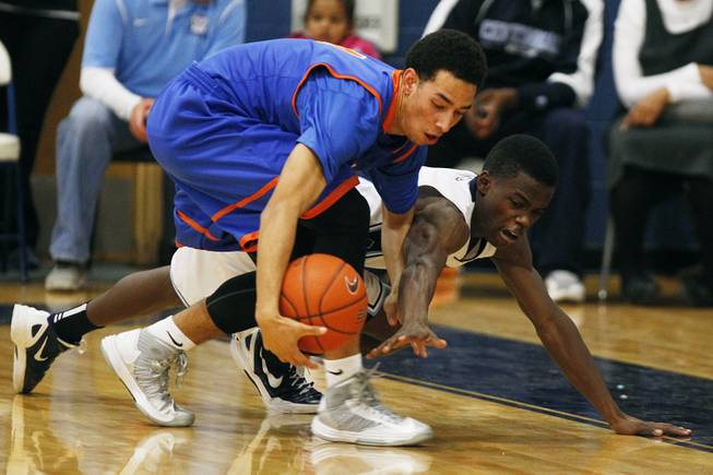 Bishop Gorman's Trey Kennedy, left, and Centennial's Marcus Allen chase a loose ball during their game Tuesday, Jan 22, 2013 at Centennial. Bishop Gorman won 79-71.