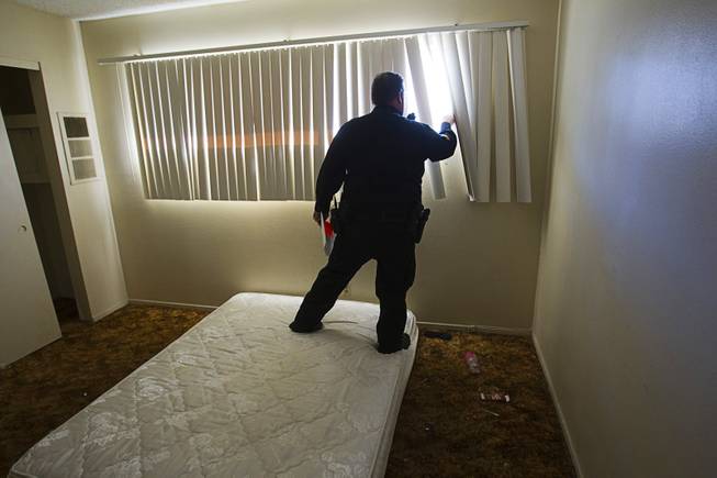 Deputy Constable Patrick Geary checks to make sure a bedroom window is secure during an eviction at an apartment near Karen Avenue and Joe W. Brown Drive Tuesday, Jan. 22, 2013. The resident had already moved out.