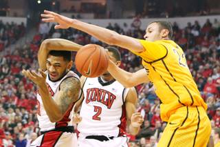 UNLV guard Anthony Marshall is fouled by Wyoming forward Larry Nance while contesting a rebound during their game Thursday, Jan. 24, 2013 at the Thomas & Mack Center.
